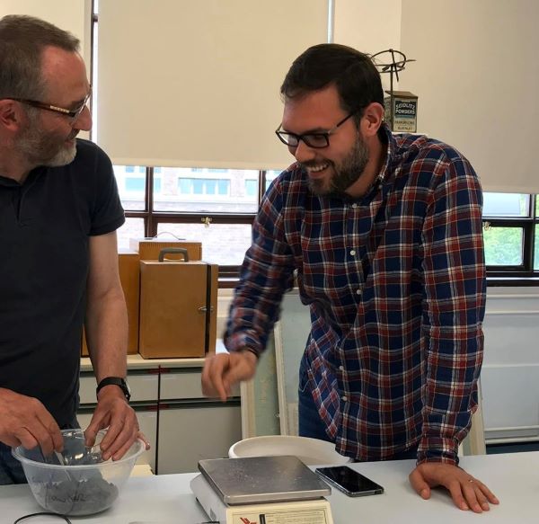 Javier Lopez Rider discussing the experimental reconstruction of medieval glass recipes with John Pearson in the Wolfson Laboratory